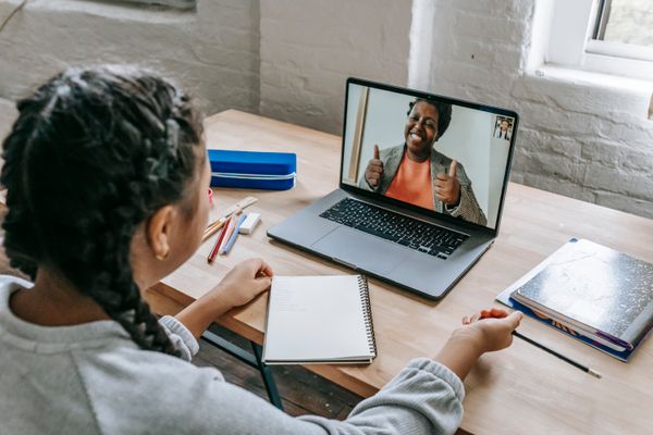 Remote leader on a video call with team members on screen